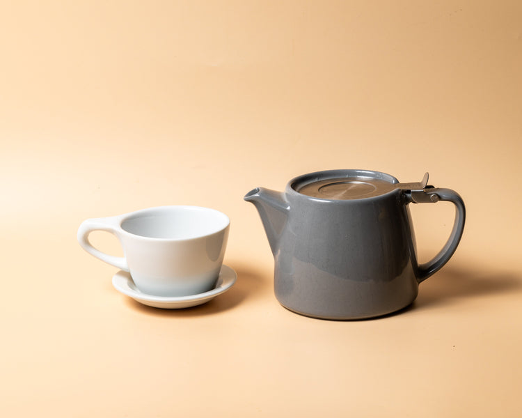 A stump teapot and cup brewing loose leaf tea