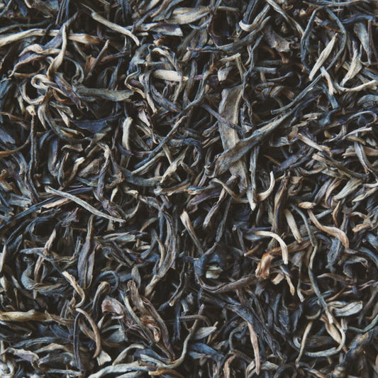 Close up view of Raw Mountain Puerh loose leaf tea leaves
